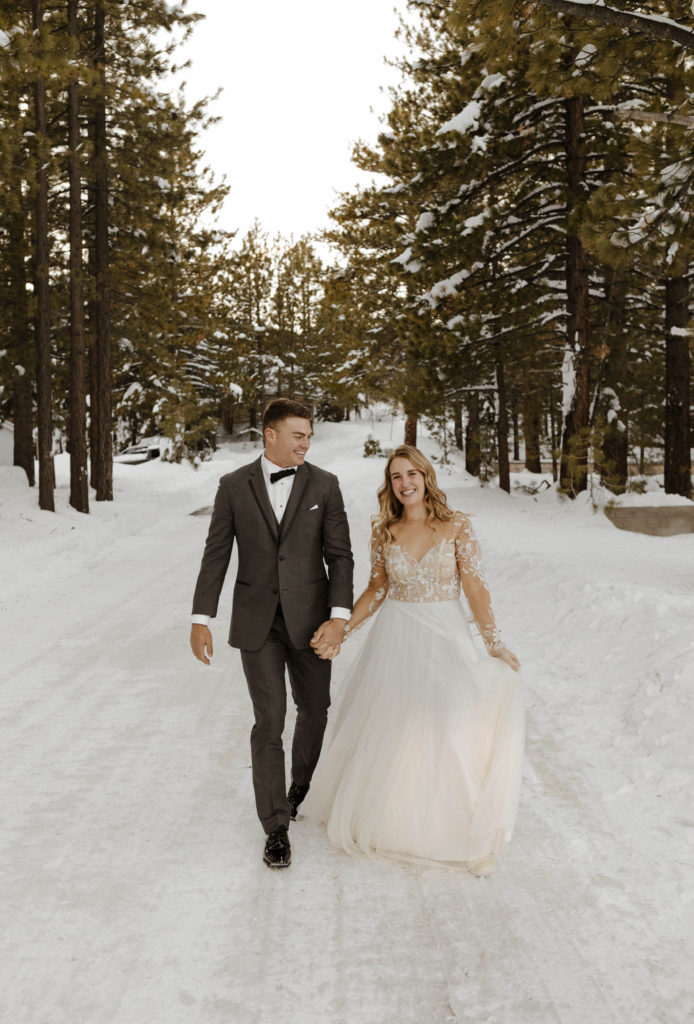 wedding couple walking down the road in the winter
