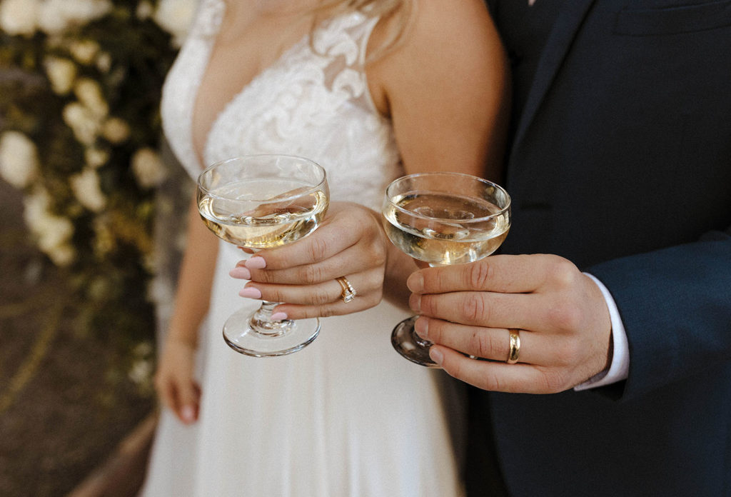 bride and groom with champagne glasses at deer park villa
