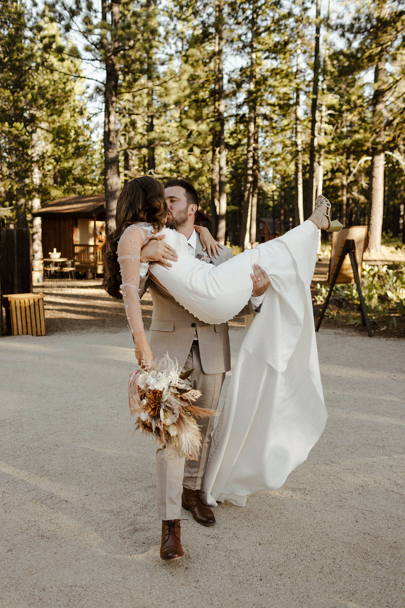groom holding bride while kissing at mitchells meadows in lake tahoe
