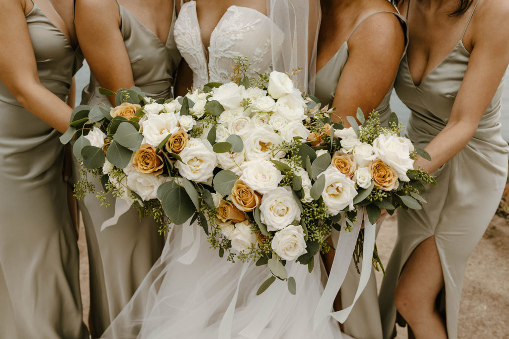 Wedding bride and bridesmaids holding floral bouquets together at carmel highlands