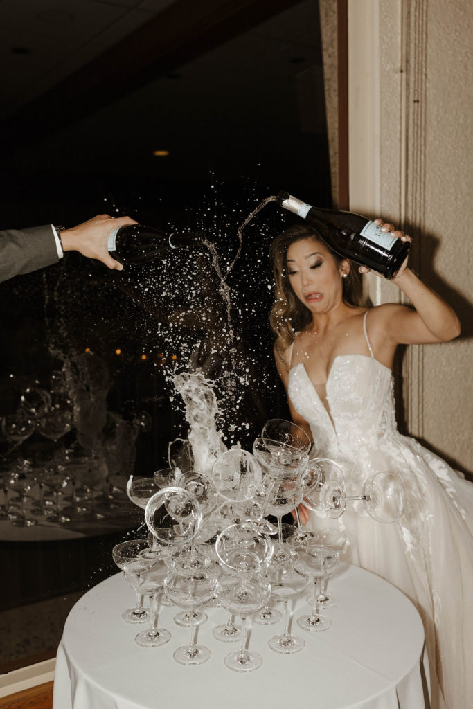 Wedding bride surprised while tower of glasses falls and breaks while pouring champagne at carmel highlands