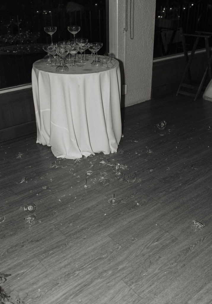 Broken glass on table and floor during reception at carmel highlands
