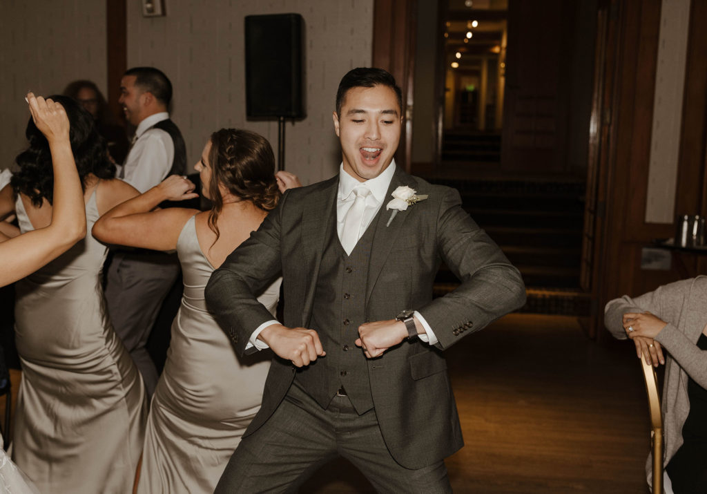 Wedding groom dancing during reception at carmel highlands