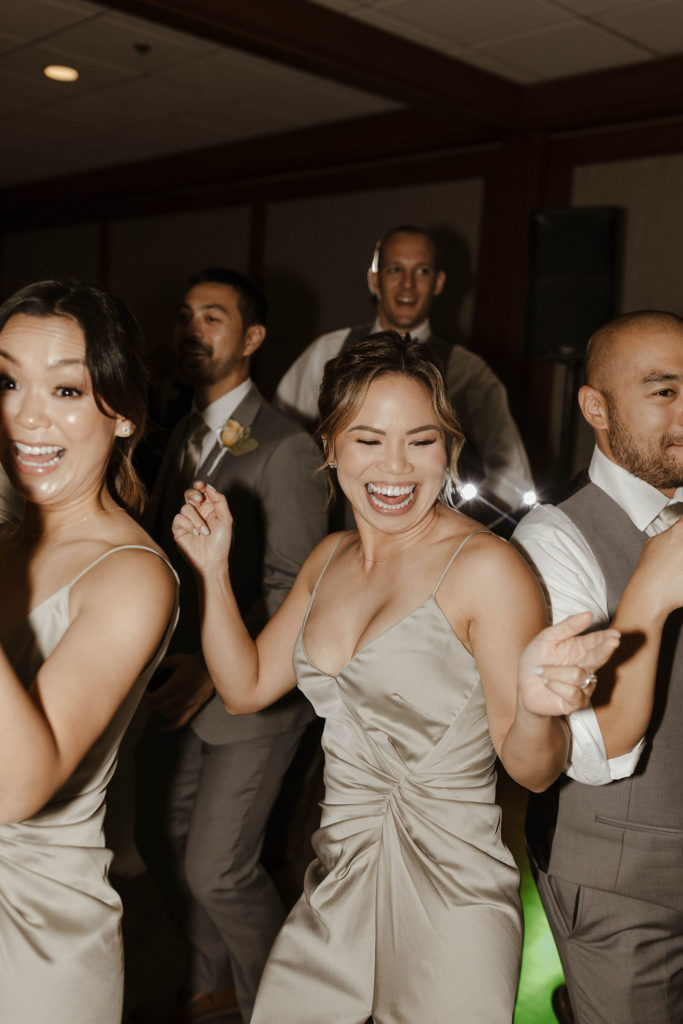 Wedding guests laughing and dancing during reception at carmel highlands