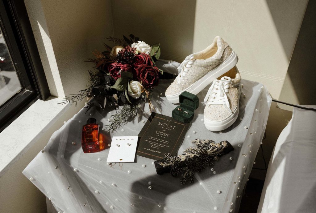 Wedding details in flat lay on table with small beads at the Bell Tower
