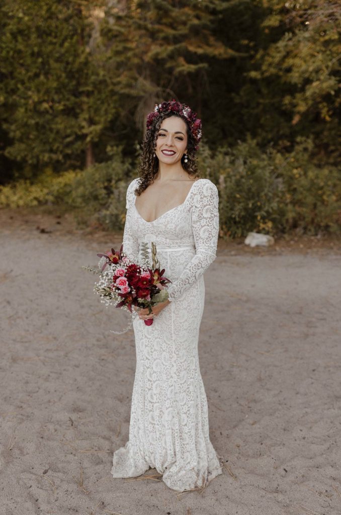 bride smiling in white lace dress in lake tahoe
