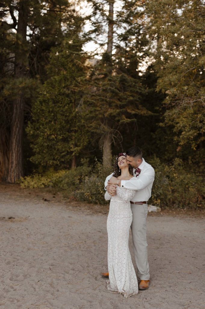 bride and groom hugging on the beach in lake tahoe