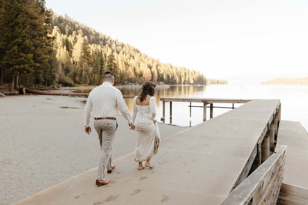 elopement couple walking on a dock in emerald bay