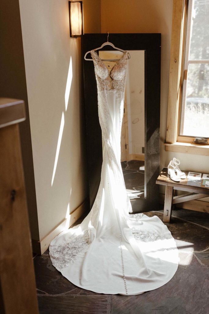 lace wedding dress hung up at the resort at squaw creek