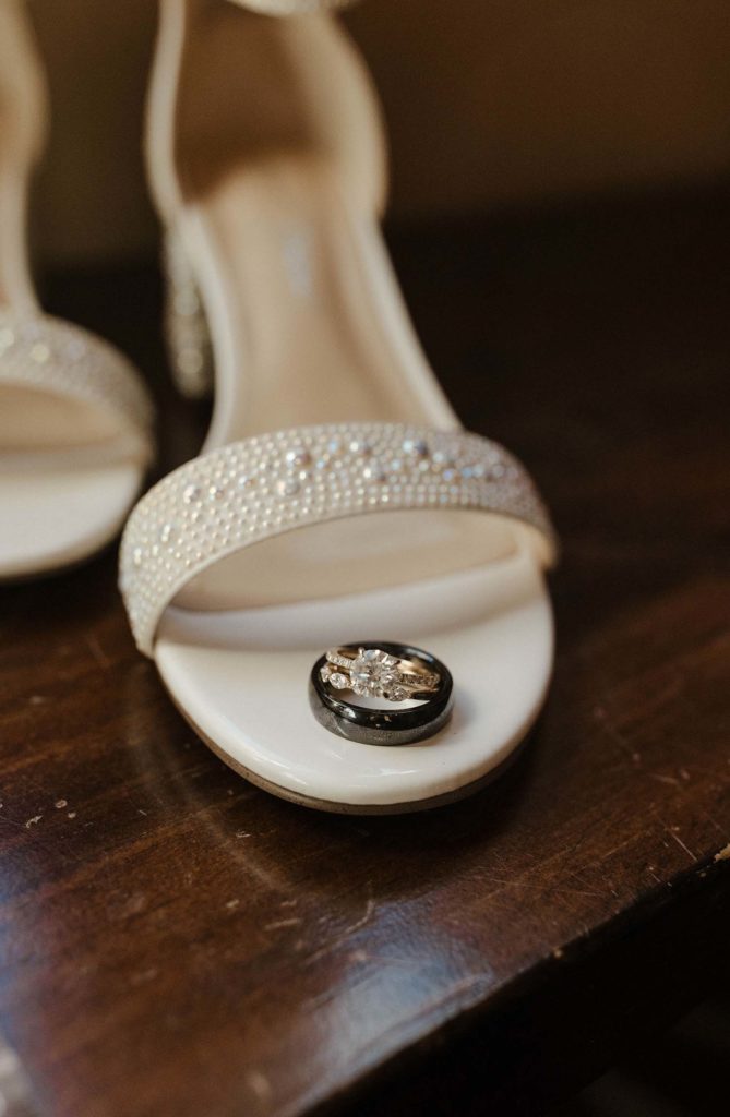 wedding rings stacked on a pearl wedding shoe at the resort at squaw creek