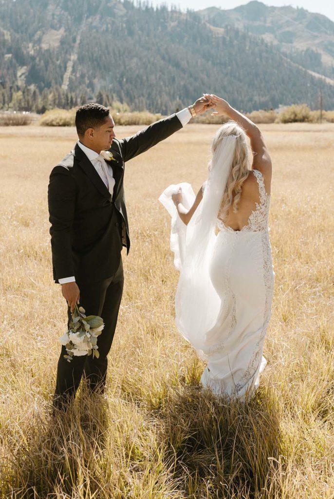 wedding couple dancing in a meadow at the resort at squaw creek