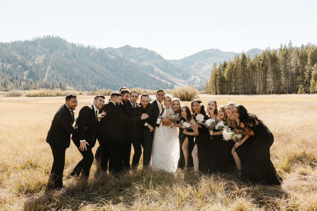 wedding party hugging and smiling at the resort at squaw creek