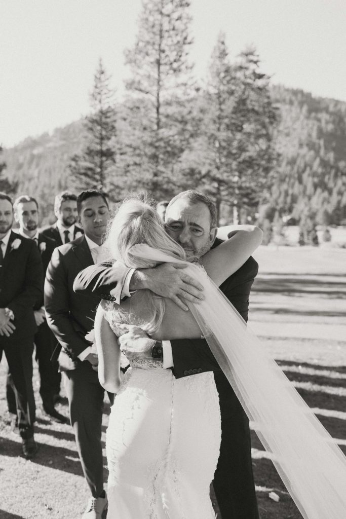 the bride hugging her dad at the ceremony at the resort at squaw creek