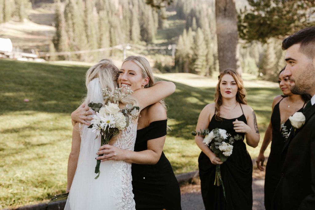 bride hugging friends at the resort at squaw creek after her wedding ceremony