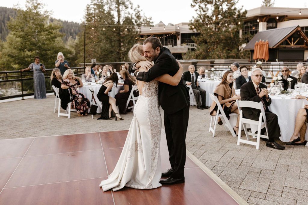 bride and her dad hugging at the resort at squaw creek