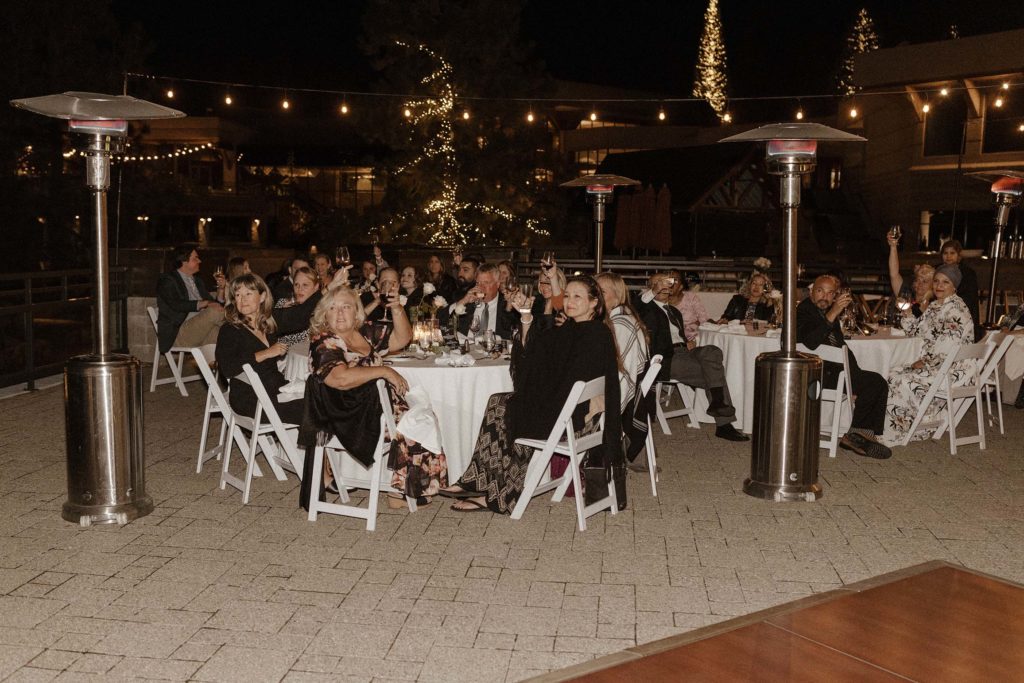 wedding guests holding up glasses at the resort at squaw creek