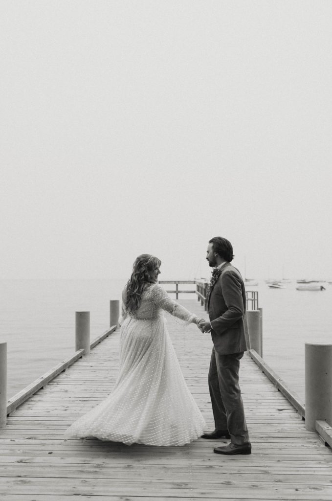 Wedding couple dancing together while on a pier in Lake Tahoe