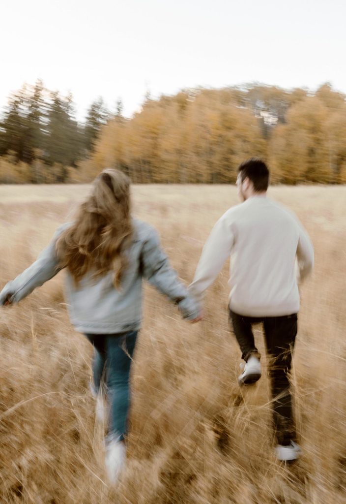 blurry photo of couple running away in a meadow in lake tahoe