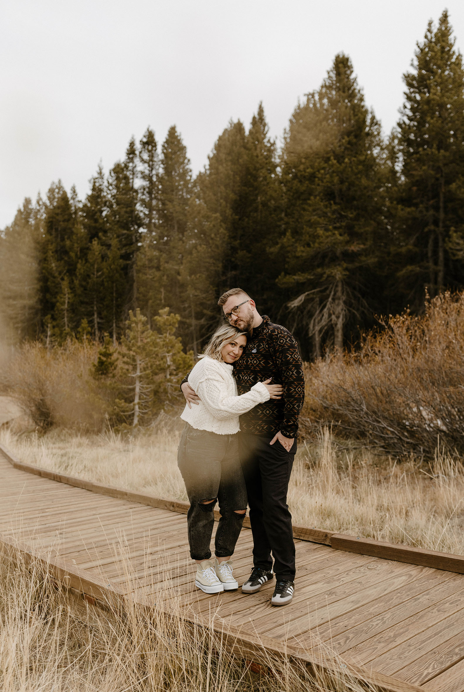 engagement couple hugging in lake tahoe meadow