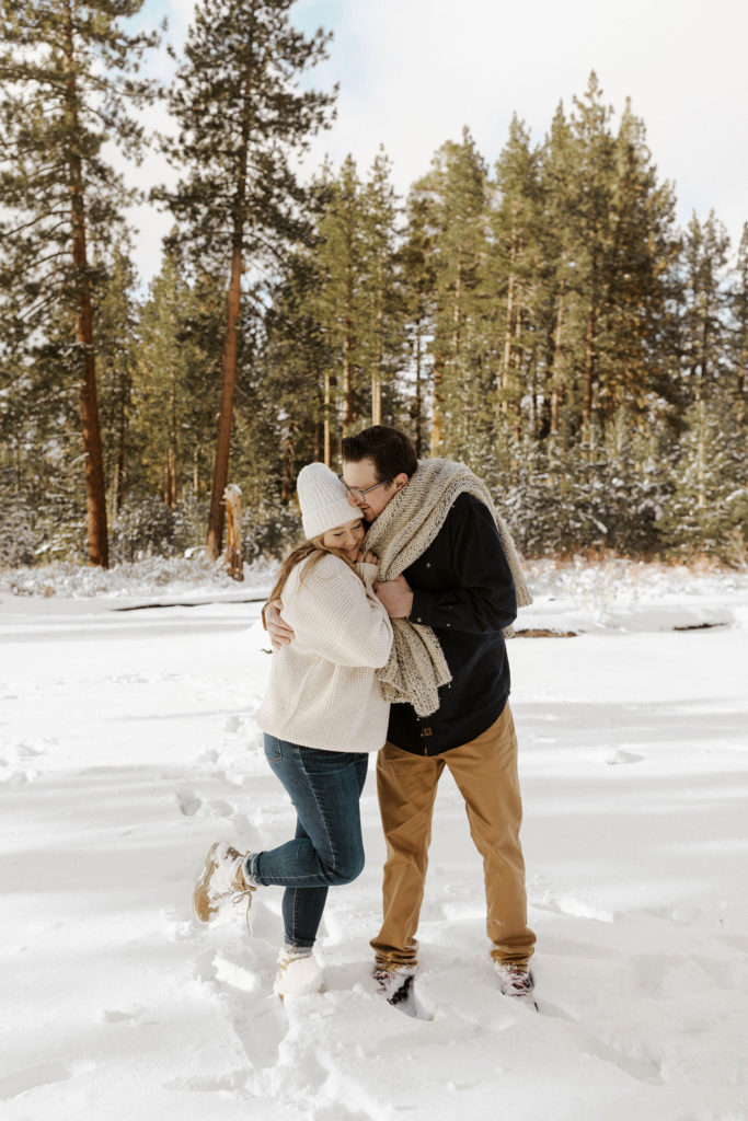 couple hugging for their winter lake tahoe engagements