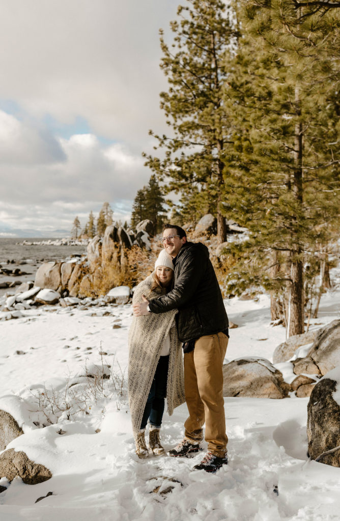 couple hugging in lake tahoe in the winter