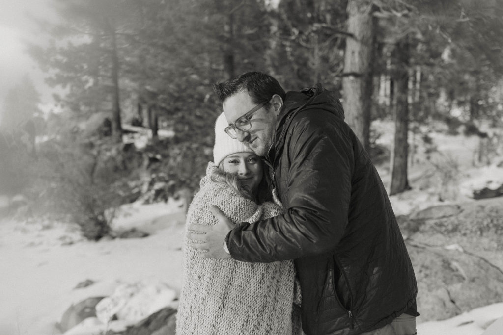 couple hugging with a blanket in lake tahoe in the winter