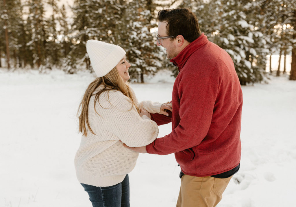 couple laughing in the snow in lake tahoe in the winter