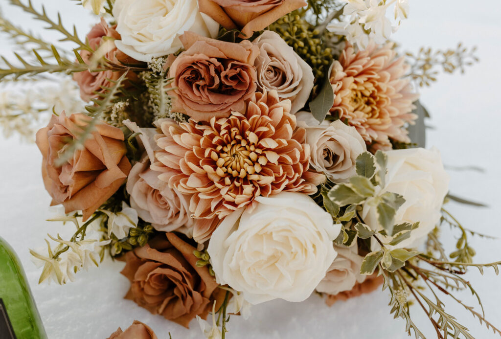 close up of a wedding bouquet with orange and pink flowers