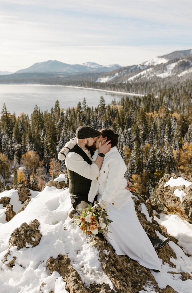 elopement couple kissing on a rock overlooking Lake Tahoe