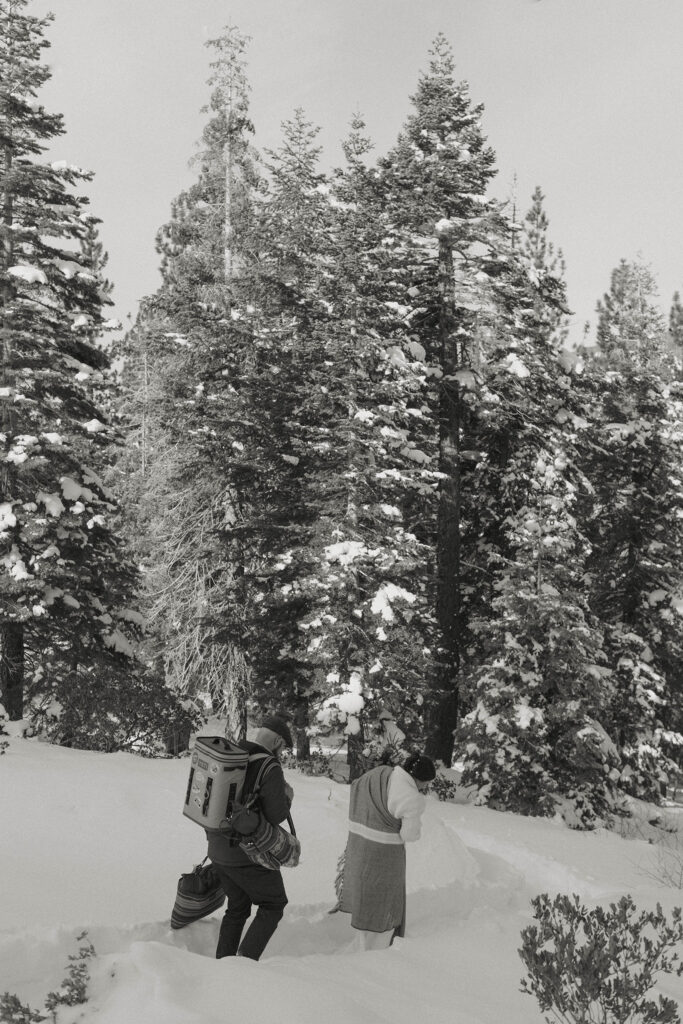 couple hiking in the snow for their lake tahoe elopement