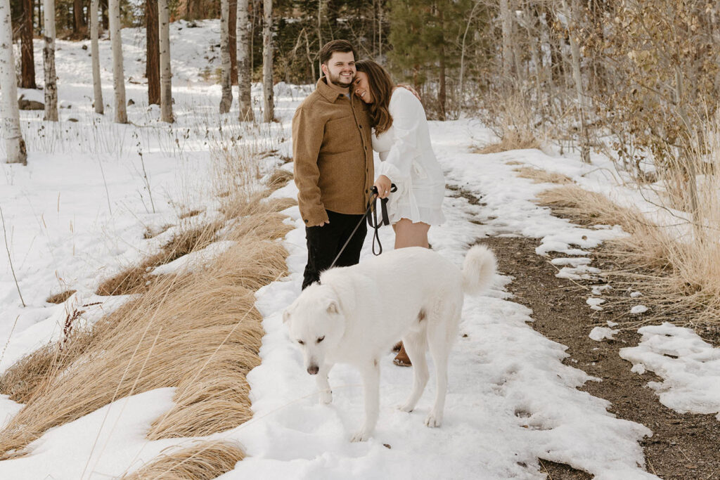 couple hugging with their dog in lake tahoe