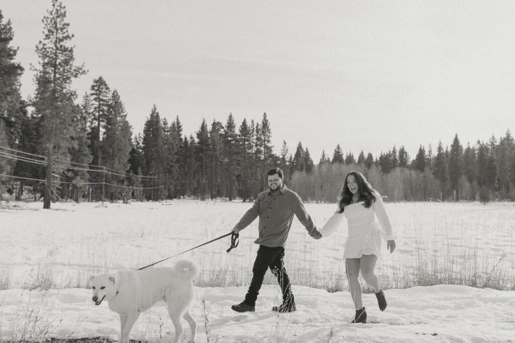 couple walking with their dog in the snow