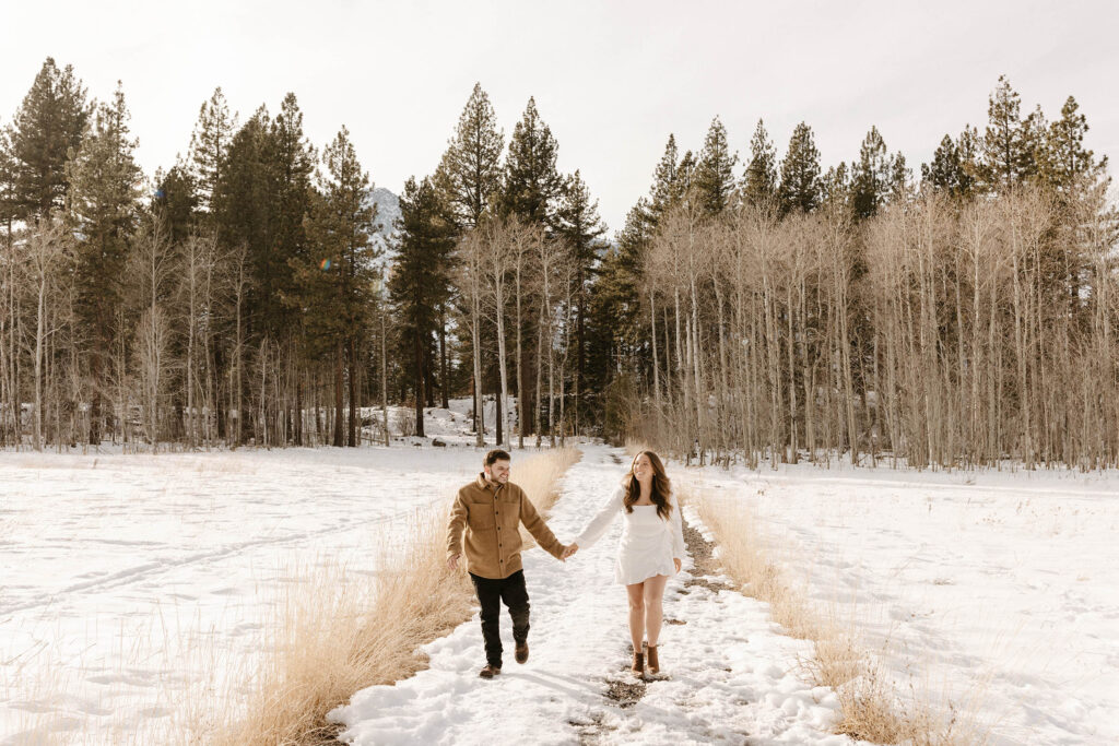 couple walking in the snow in lake tahoe