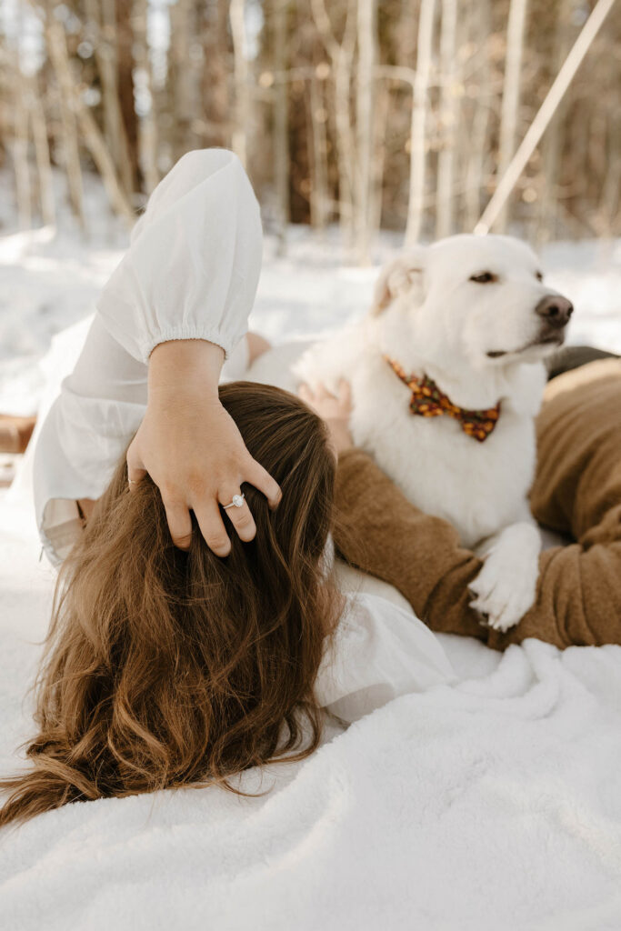 woman playing with her hair as her dog is in the background