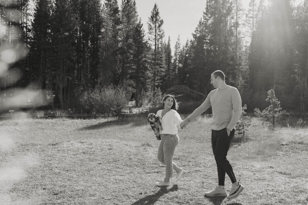 engagement couple walking in mount rose meadows with their dog