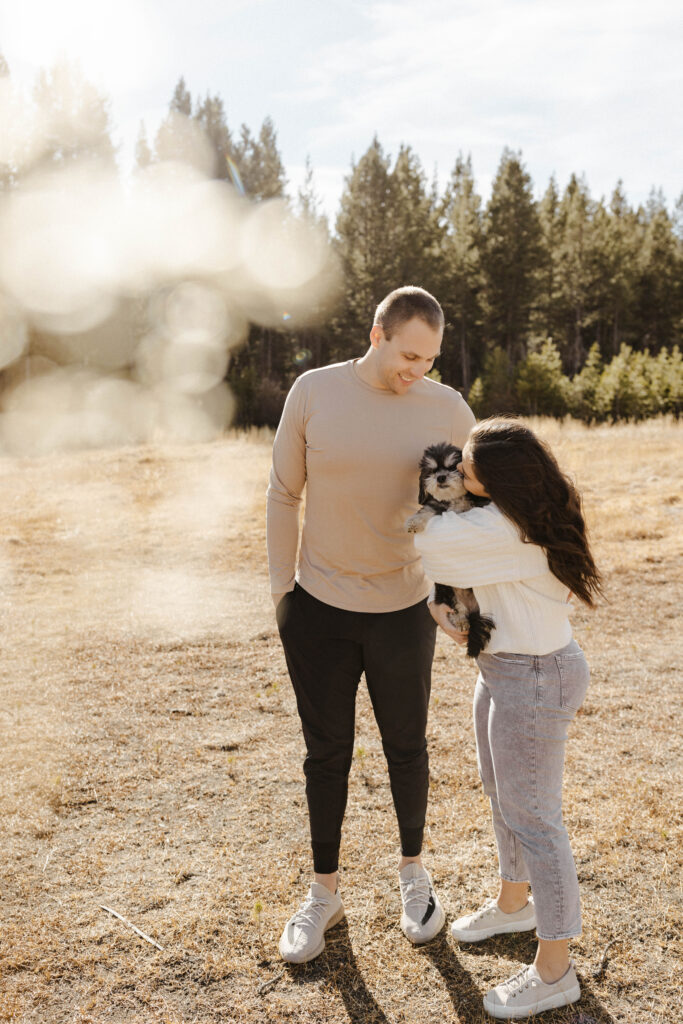 couple kissing their dog at Mount Rose Meadows