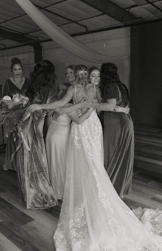 bride hugging her bridesmaids at tuscan falls