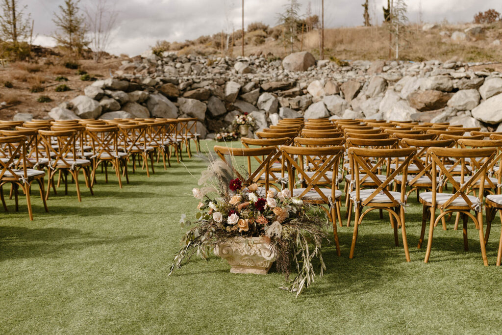 wedding ceremony chairs and florals setup at tuscan falls wedding