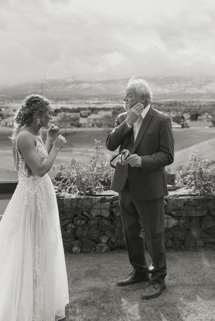 bride's dad wiping tears after sharing a first look