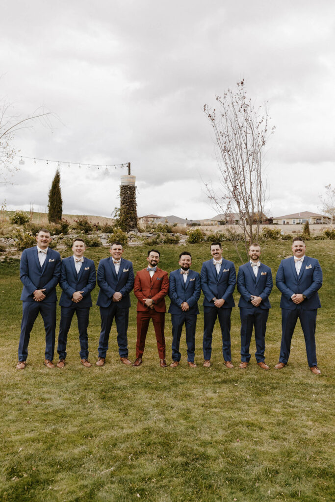 groom and groomsmen smiling at tuscan falls wedding