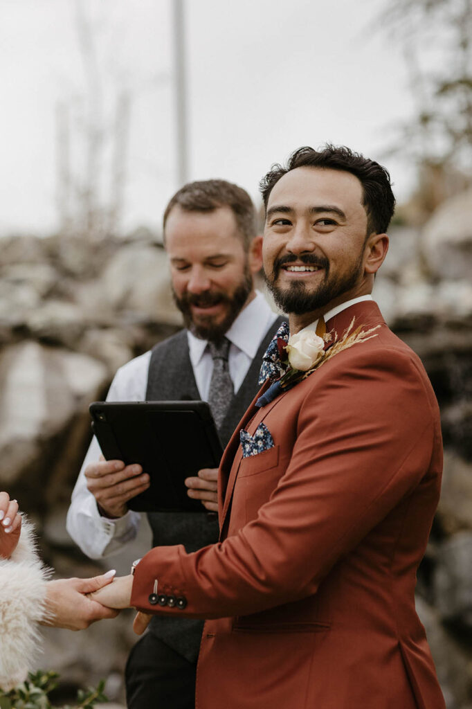 groom smiling during his wedding ceremony