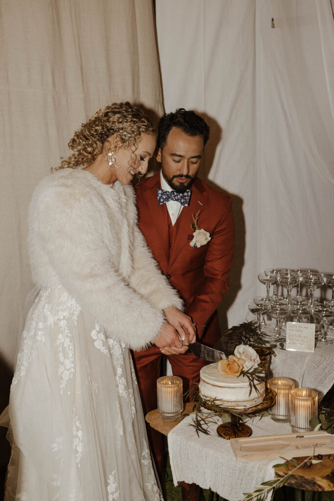 bride and groom cutting cake at tuscan falls wedding