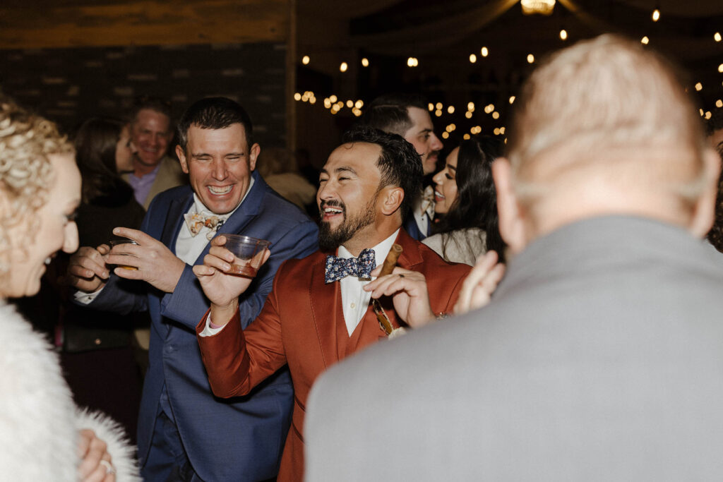 groom and groomsmen laughing at tuscan falls wedding