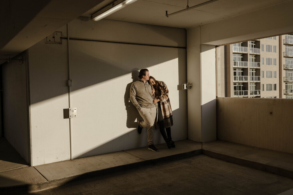 couple standing in a parking garage in the sun in reno