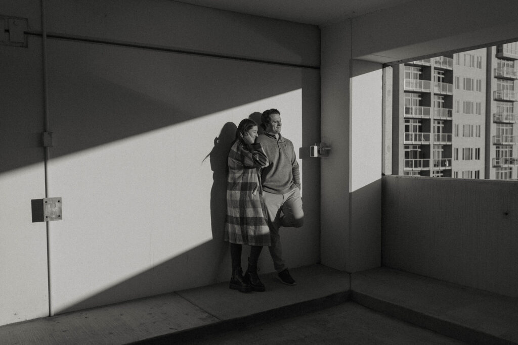 couple standing in a parking garage in the sun in reno
