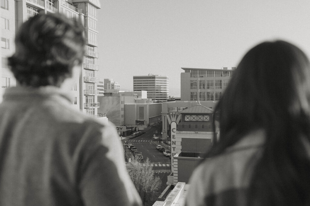 couple blurry overlooking downtown reno for their engagement photos