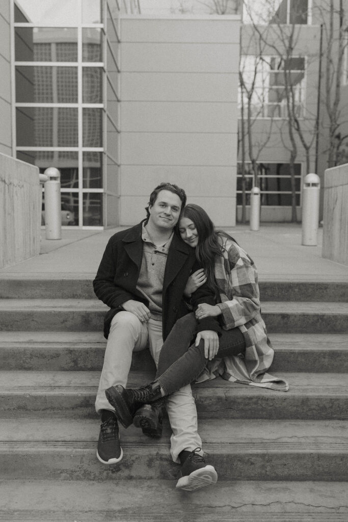 engagement couple sitting on stairs in downtown reno 