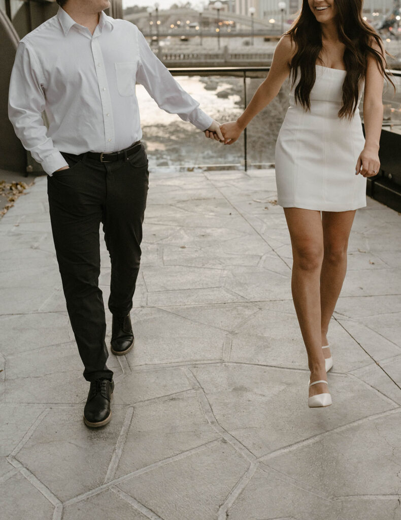 close up photo of an engagement couple walking in nice clothing in downtown reno