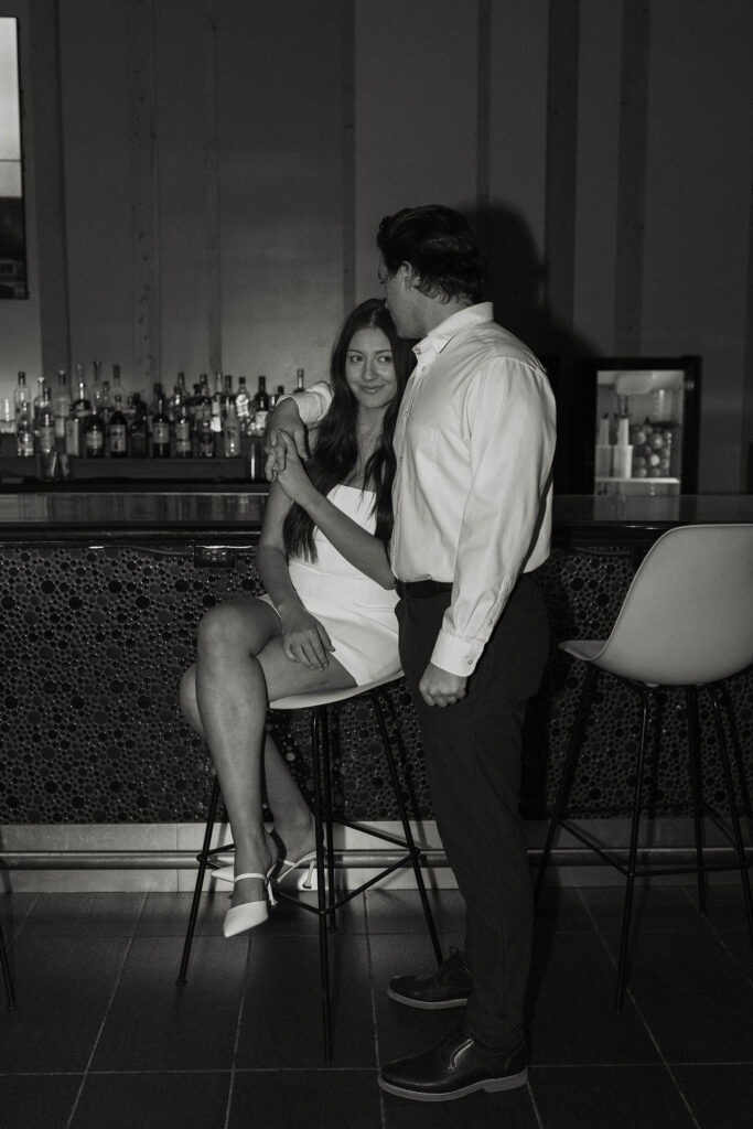 engagement couple sitting at a bar in downtown reno