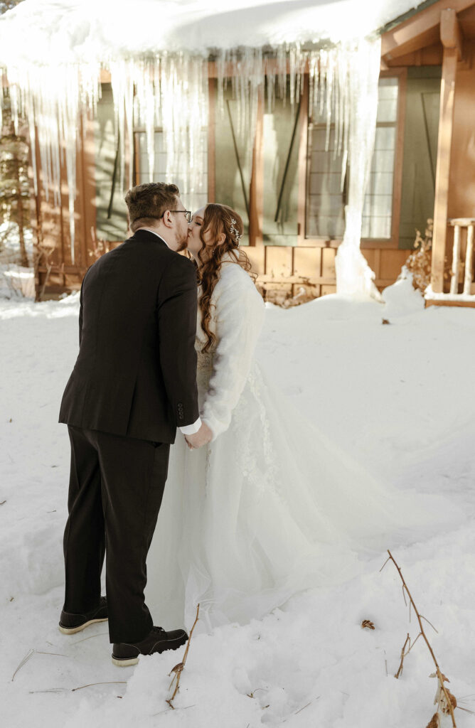 bride and groom kissing in the snow in lake tahoe